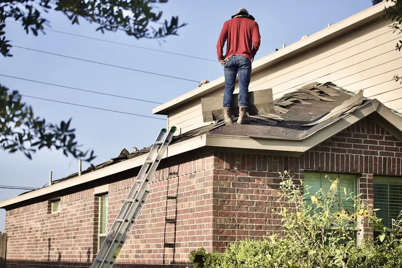 Professional roofer working on a residential roof in Jeter Mountain Terrace